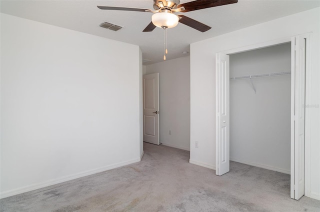 unfurnished bedroom featuring carpet floors, a closet, ceiling fan, and baseboards