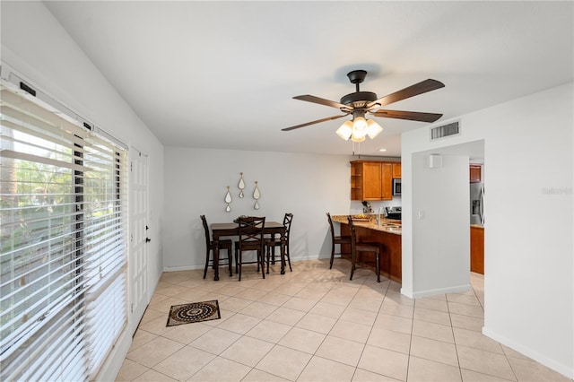 108 Biscayne Ave Unit B, Tampa, FL 33606 - dining area with light tile patterned floors, ceiling fan, and baseboards