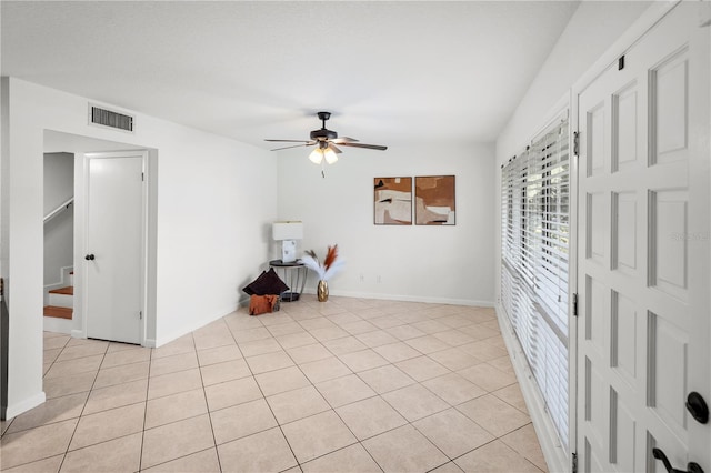 108 Biscayne Ave Unit B, Tampa, FL 33606 - unfurnished room featuring ceiling fan, light tile patterned flooring, baseboards, and stairs