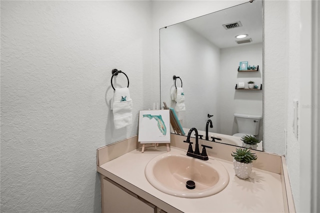108 Biscayne Ave Unit B, Tampa, FL 33606 - half bath with a textured wall, vanity, and toilet