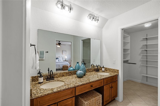 108 Biscayne Ave Unit B, Tampa, FL 33606 - ensuite bathroom with tile patterned flooring, double vanity, ceiling fan, and a textured ceiling