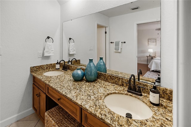 108 Biscayne Ave Unit B, Tampa, FL 33606 - bathroom featuring double vanity, tile patterned flooring, ensuite bathroom, and baseboards