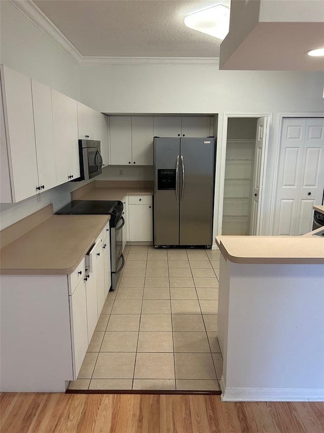 3145 Meta Ct, Largo, FL 33771 - kitchen with appliances with stainless steel finishes, ornamental molding, white cabinetry, light countertops, and light wood-type flooring