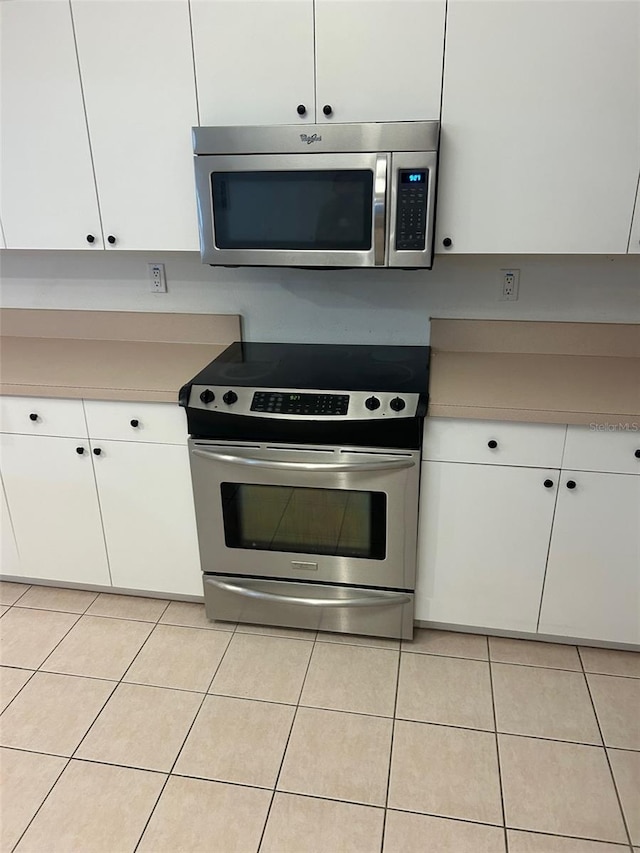 3145 Meta Ct, Largo, FL 33771 - kitchen featuring appliances with stainless steel finishes, light tile patterned flooring, and light countertops
