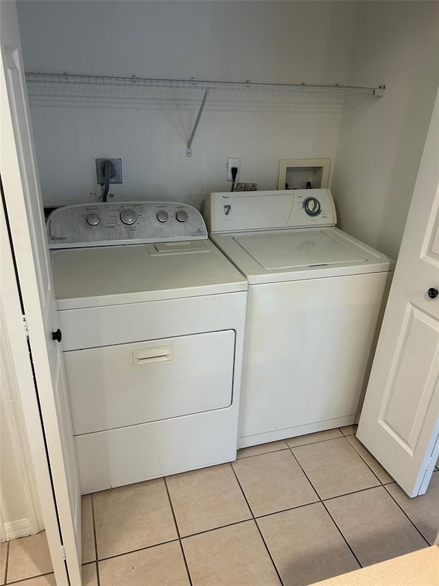 3145 Meta Ct, Largo, FL 33771 - washroom featuring washing machine and dryer and light tile patterned floors