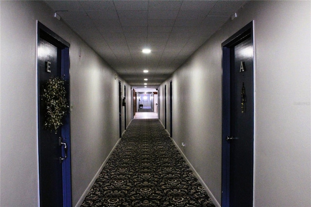 hall featuring carpet floors, baseboards, and recessed lighting