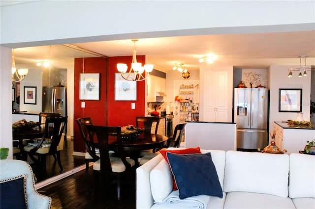 living room with a chandelier and wood finished floors