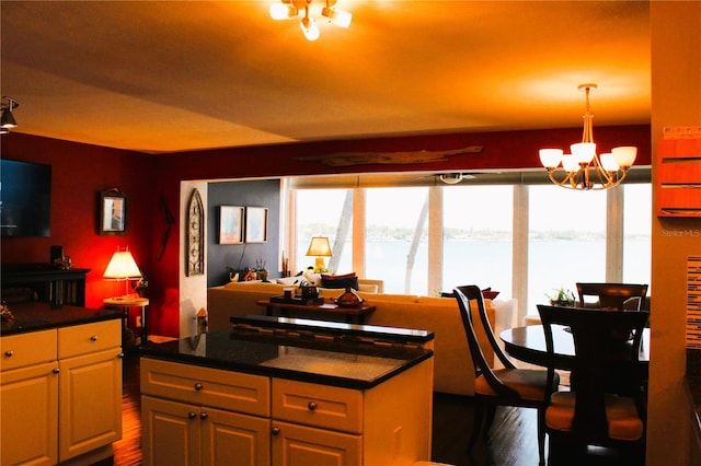 kitchen featuring dark wood-style floors, a chandelier, and dark countertops