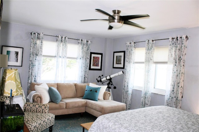 bedroom featuring multiple windows and a ceiling fan