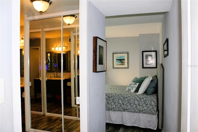 bedroom featuring wood finished floors and a sink