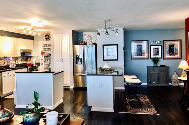 7200 Sunshine Skyway Ln S Unit 2E, Saint Petersburg, FL 33711 - kitchen with appliances with stainless steel finishes, dark countertops, a kitchen island, dark wood-style flooring, and white cabinetry