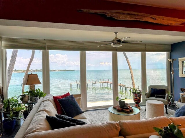 7200 Sunshine Skyway Ln S Unit 2E, Saint Petersburg, FL 33711 - living room featuring a water view, ceiling fan, plenty of natural light, and beam ceiling