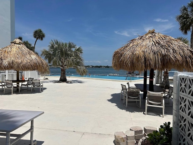 7200 Sunshine Skyway Ln S Unit 2E, Saint Petersburg, FL 33711 - community pool with a patio and outdoor dining area