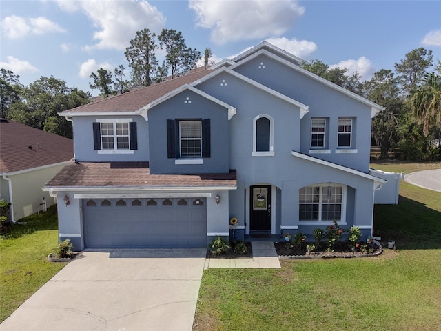 traditional-style house with driveway, stucco siding, a front yard, and an attached garage