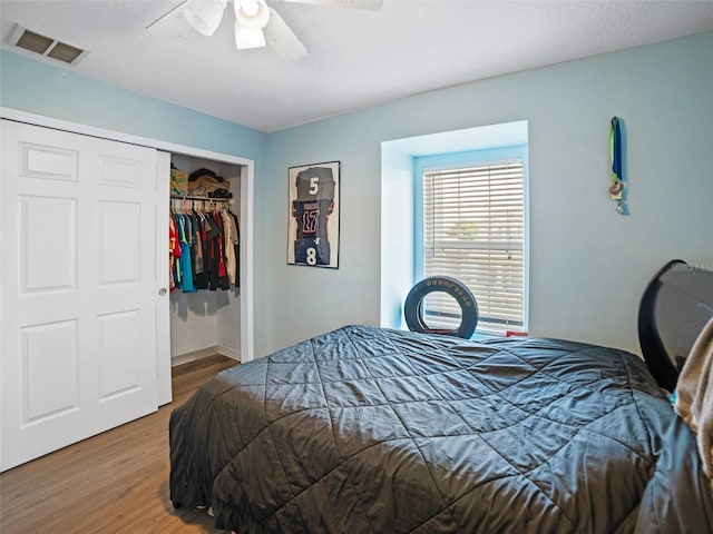 bedroom with wood finished floors, a closet, and ceiling fan