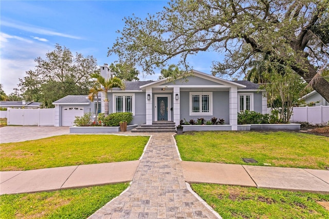 493 Lucerne Ave, Tampa, FL 33606 - ranch-style home with an attached garage, driveway, stucco siding, and a chimney