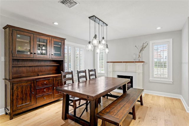 493 Lucerne Ave, Tampa, FL 33606 - dining space with light wood finished floors, plenty of natural light, a fireplace, and recessed lighting