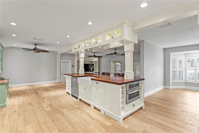 493 Lucerne Ave, Tampa, FL 33606 - kitchen featuring wood counters, decorative columns, a ceiling fan, and recessed lighting
