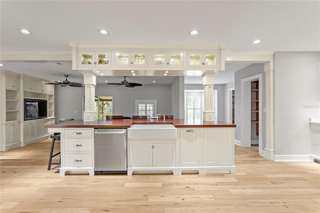 493 Lucerne Ave, Tampa, FL 33606 - kitchen with butcher block countertops, dishwasher, ornate columns, a ceiling fan, and a sink