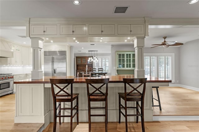493 Lucerne Ave, Tampa, FL 33606 - kitchen featuring high quality appliances, ornate columns, light wood-type flooring, a ceiling fan, and recessed lighting
