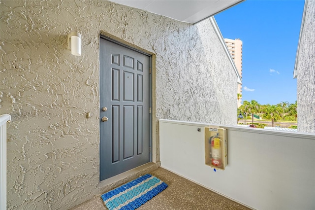 1351 Gulf Blvd Unit 209, Clearwater Beach, FL 33767 - doorway to property with stucco siding and a balcony