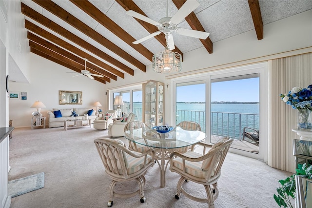 1351 Gulf Blvd Unit 209, Clearwater Beach, FL 33767 - dining room featuring a ceiling fan, light colored carpet, and a water view