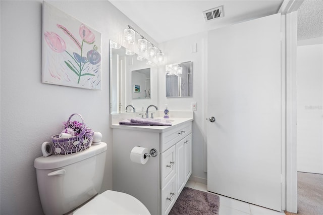 1351 Gulf Blvd Unit 209, Clearwater Beach, FL 33767 - half bathroom with toilet, tile patterned floors, and vanity