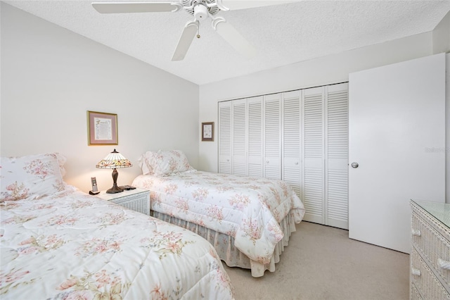 1351 Gulf Blvd Unit 209, Clearwater Beach, FL 33767 - bedroom featuring light colored carpet, a closet, ceiling fan, a textured ceiling, and vaulted ceiling