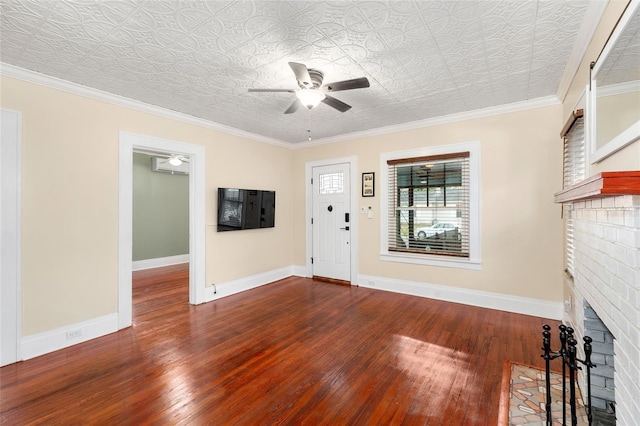931 28th Ave N, Saint Petersburg, FL 33704 - foyer featuring ceiling fan, wood-type flooring, a brick fireplace, baseboards, and an ornate ceiling