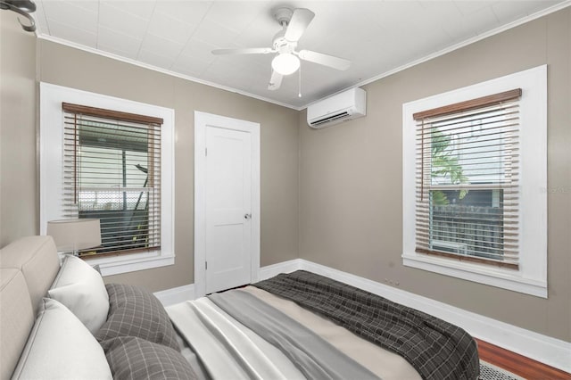931 28th Ave N, Saint Petersburg, FL 33704 - bedroom featuring a wall unit AC, crown molding, baseboards, a ceiling fan, and wood finished floors