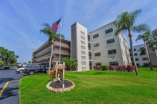 view of building exterior featuring uncovered parking