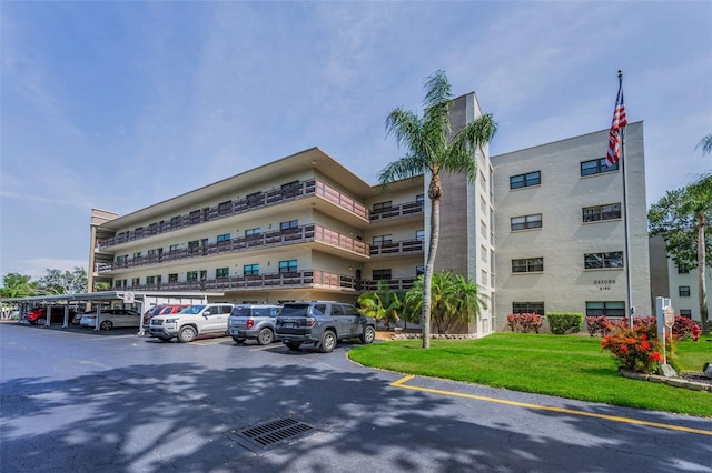 view of building exterior with uncovered parking