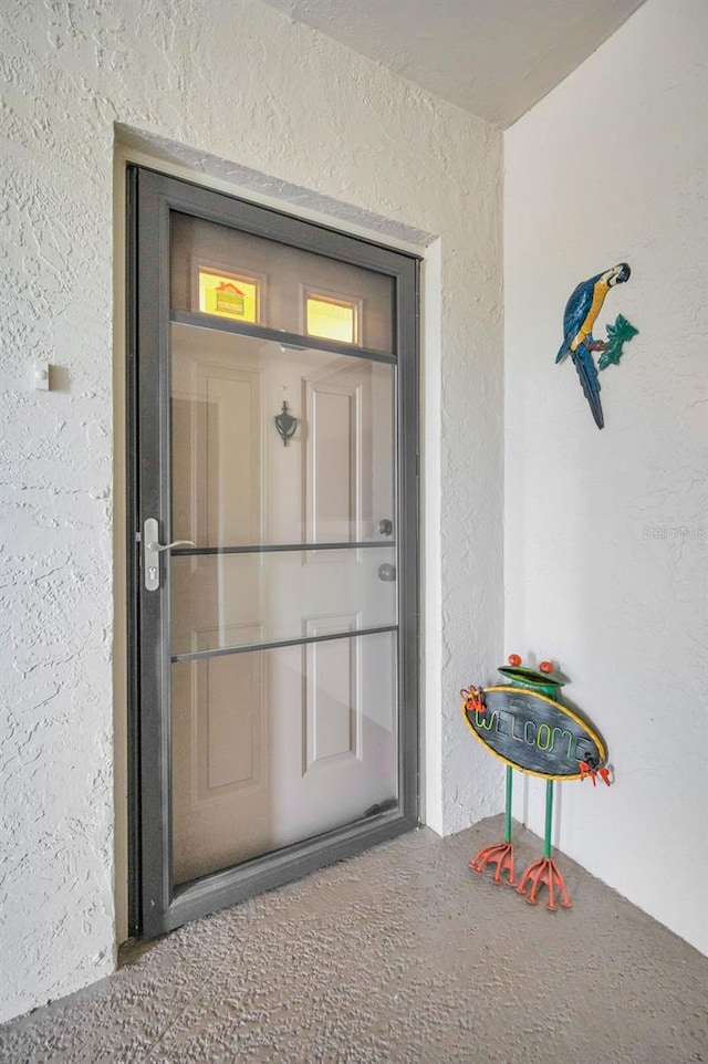 entrance to property with stucco siding