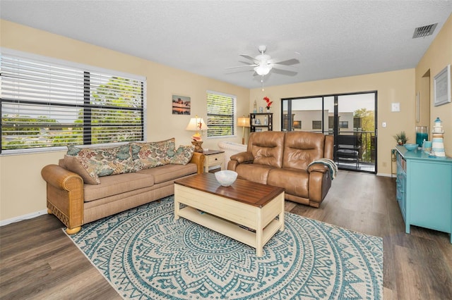 living area featuring ceiling fan, wood finished floors, a textured ceiling, and baseboards
