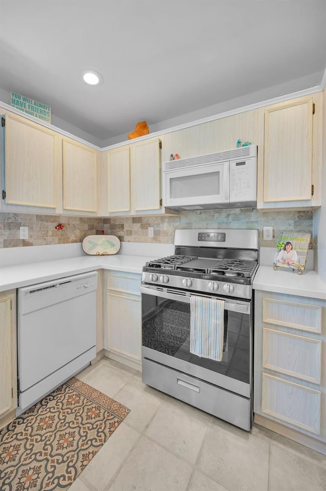 kitchen featuring white appliances, light brown cabinets, light countertops, tasteful backsplash, and recessed lighting