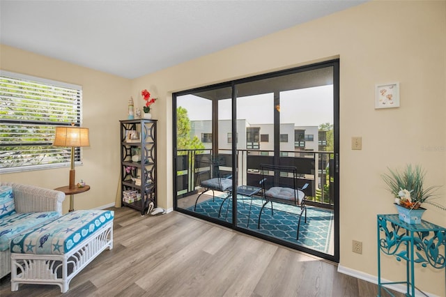 living area with wood finished floors and baseboards