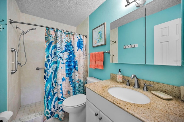 bathroom with a textured ceiling, tiled shower, vanity, and toilet