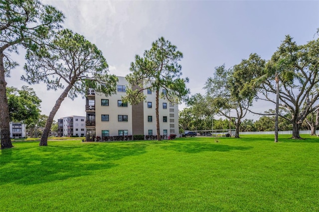 view of property's community featuring a yard and a water view