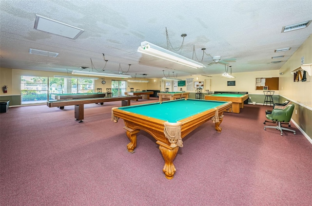 playroom featuring billiards, a textured ceiling, carpet, ceiling fan, and baseboards