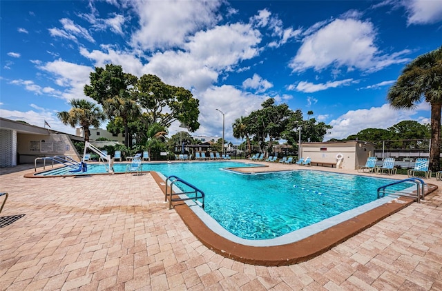 community pool featuring a patio and fence