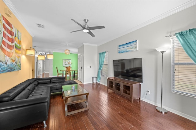 living room with a ceiling fan, crown molding, wood finished floors, and baseboards