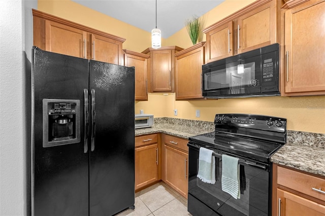 kitchen with black appliances, light tile patterned floors, light stone counters, and brown cabinetry