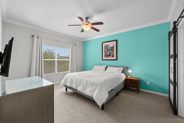 bedroom featuring a barn door, light colored carpet, ornamental molding, baseboards, and a ceiling fan