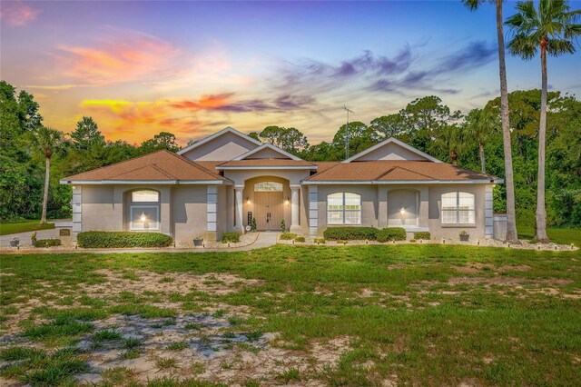 7206 River Country Dr, Weeki Wachee, FL 34607 - mediterranean / spanish-style house with a lawn and stucco siding