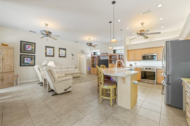 7206 River Country Dr, Weeki Wachee, FL 34607 - kitchen with appliances with stainless steel finishes, ceiling fan, open floor plan, light tile patterned floors, and light countertops
