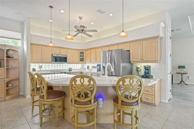 7206 River Country Dr, Weeki Wachee, FL 34607 - kitchen featuring stainless steel appliances, light brown cabinetry, a ceiling fan, light tile patterned flooring, and glass insert cabinets
