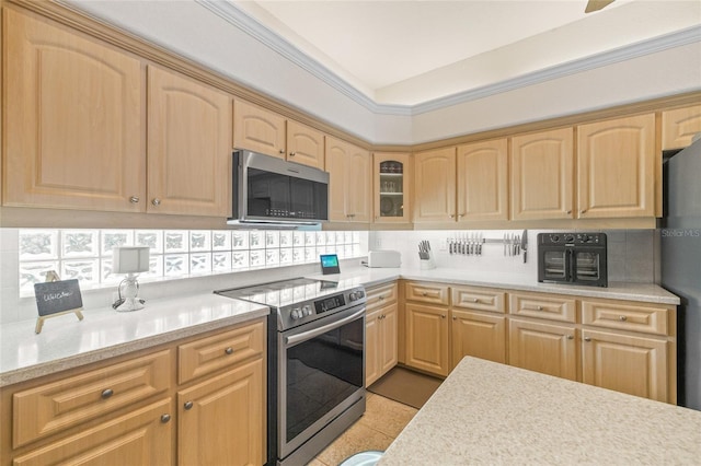 7206 River Country Dr, Weeki Wachee, FL 34607 - kitchen with appliances with stainless steel finishes, light brown cabinetry, and light countertops