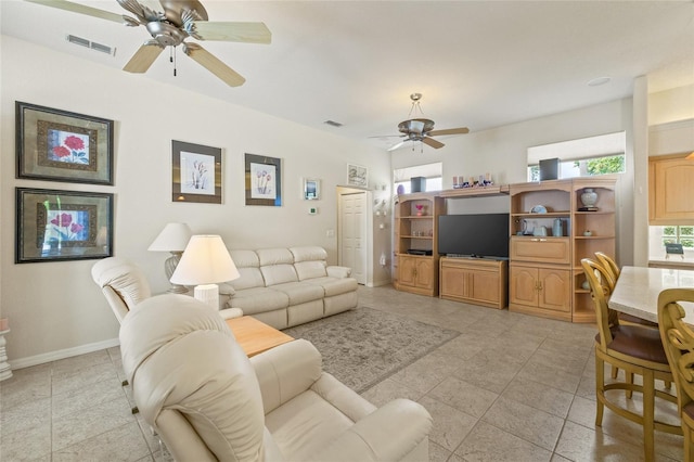 7206 River Country Dr, Weeki Wachee, FL 34607 - living room featuring a ceiling fan, light tile patterned floors, and baseboards