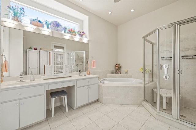 7206 River Country Dr, Weeki Wachee, FL 34607 - full bath featuring tile patterned flooring, a stall shower, a bath, vanity, and recessed lighting