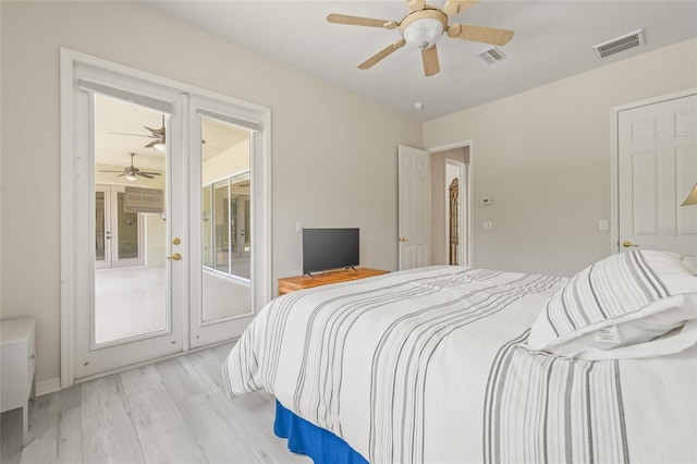 7206 River Country Dr, Weeki Wachee, FL 34607 - bedroom featuring access to outside, light wood finished floors, french doors, and ceiling fan